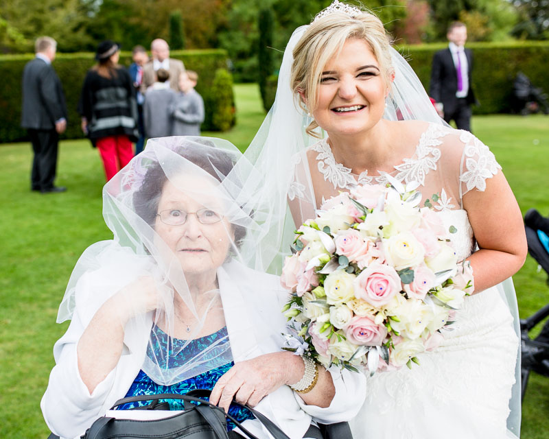 fun photo of bride and her gran with the veil on gran's head
