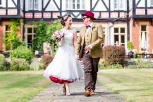 Bride and Groom walking hand in hand at a Norfolk Wedding Venue