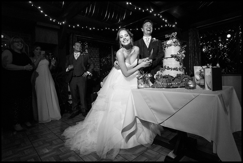 cutting wedding cake in pub