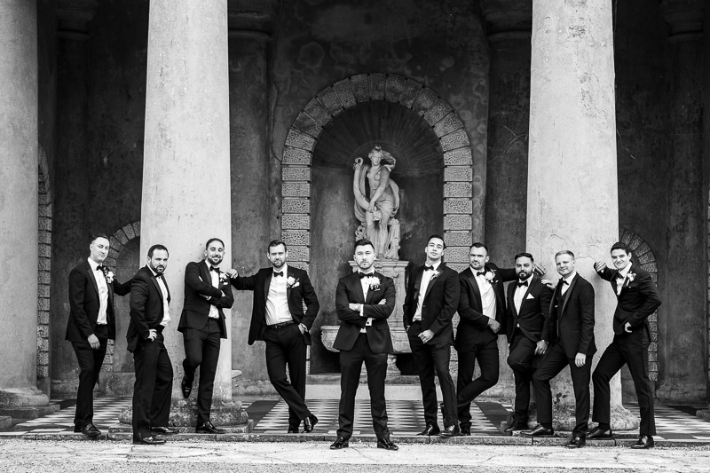 Groomsmen in cool pose in front of temple at De Vere Wotton House